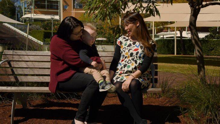 Amanda Darragh (left) with her son Blake Darragh (2nd from left) 21months talks with Paediatric radiation oncologist Jennifer Chard (right) in the gardens at the Children's Hospital at West Mead. Blake was diagnosed with cancer at 6months old. He has recieved both chemo therapy and Braky therapy. Sydney. 5th September, 2017. Photo: Kate Geraghty