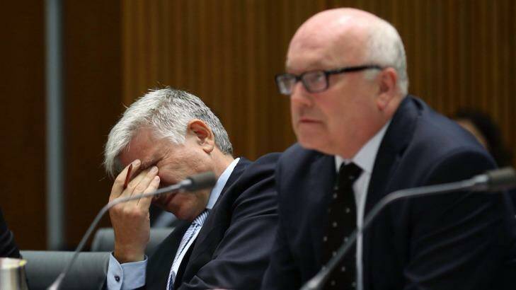 Attorney-General Senator George Brandis and Department Secretary Chris Moraitis appeared before a Senate Committee in Canberra on Tuesday. Photo: Andrew Meares