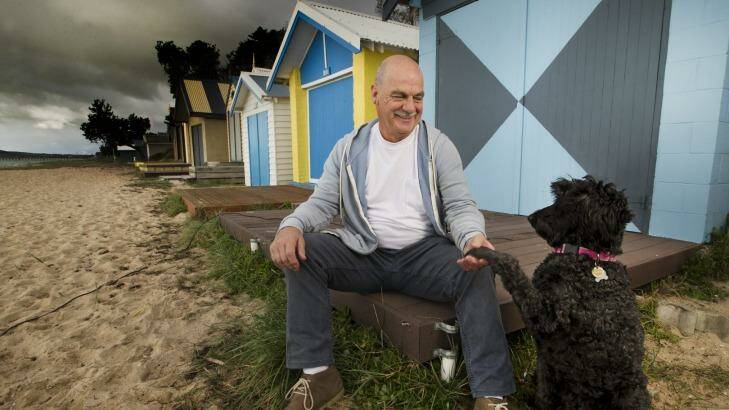Kevin Egan relaxes on the beach at home in Rye with his dog, Lola.  Photo: Simon O'Dwyer