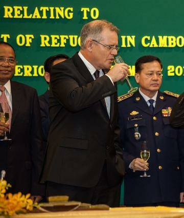 Immigration Minister Scott Morrison and Cambodian Interior Minister Sar Kheng toast their deal in September last year. Photo: Omar Havana