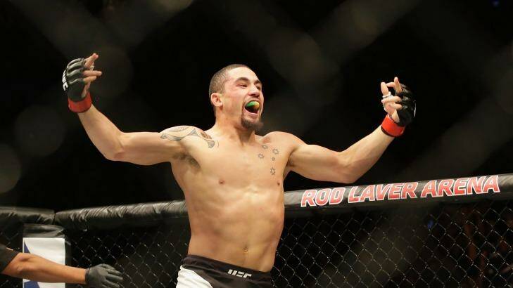 Fast finisher: Robert Whittaker celebrates after knocking out Derek Brunson in round one. Photo: Darrian Traynor