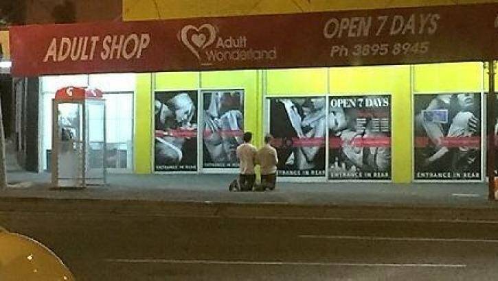 A photo posted on Reddit showing two men praying outside Annerley's Adult Wonderland last week. Photo: Reddit
