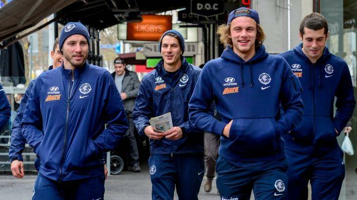 ?Lygon Street limbo: While the search for a new coach goes on, Blues players promote the AFL's multicultural round in Carlton. Photo: Penny Stephens