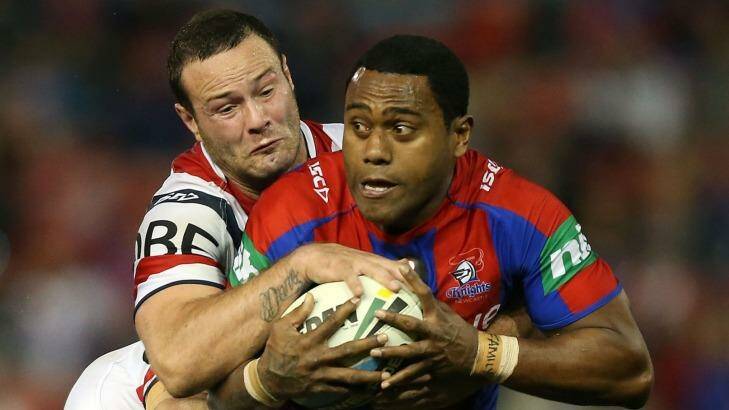 Akuila Uate, right, of the Knights is tackled by the Roosters defence during the round 22 NRL match agasinst the Roosters at Hunter Stadium on August 9. Photo: Tony Feder
