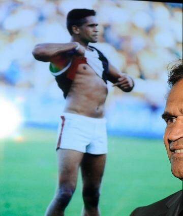 Nicky Winmar at the launch of the AFL Indigenous Round in 2013. In the background is the famous picture of him taking a stand against racism.  Photo: Sebastian Costanzo