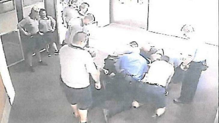 Five staff members appear to hold the teenager down. Photo: Supplied
