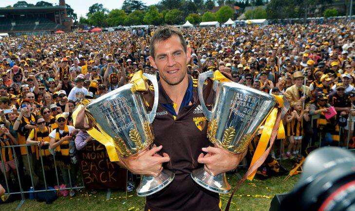 AFL Hawthorn bring the premiership cup home to Glenferrie oval. Hawthorn Captain Luke Hodge with the 2014 and 2013 cups. 28th of September 2014 The Age news Picture by JOE ARMAO