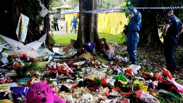 Forensic officers collect evidence at the memorial for eight children killed in Cairns. Photo: Edwina Pickles