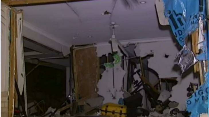 There were no injuries when a car was driven through a house in Brisbane. Photo: Nine News