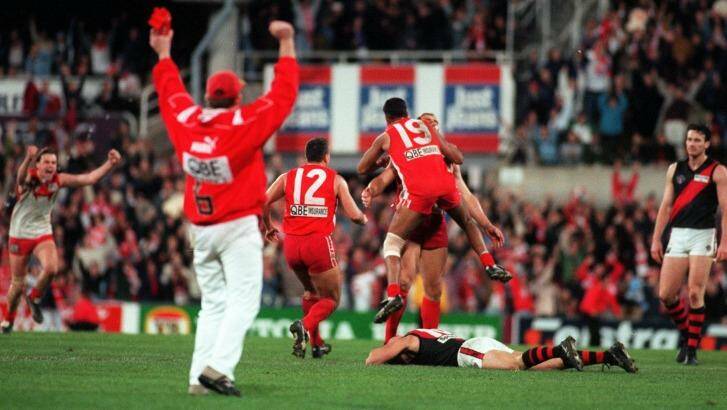 Sydney Swans players congratulate Tony Lockett after he kicked a behind to put them through to the grand final. Photo taken 21 September 1996. Photo: Steve Christo