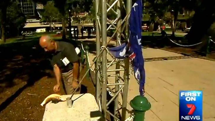 A man sets fire to the Australian flag in Brisbane's Anzac Square just a day before Anzac Day. Photo: Seven News