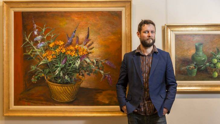 Artist Ben Quilty standing in front of Margaret Olley's artwork being exhibited for the first time at the Philip Bacon Galleries. Photo: Glenn Hunt