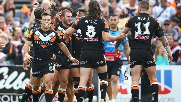 Source of contention: Robbie Farah celebrates with his teammates after scoring a try during the round 25 NRL match between the Wests Tigers and the New Zealand Warriors at Campbelltown Sports Stadium. Photo: Mark Kolbe