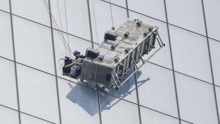 One of two window-washers is pulled to safety. Photo: New York TImes