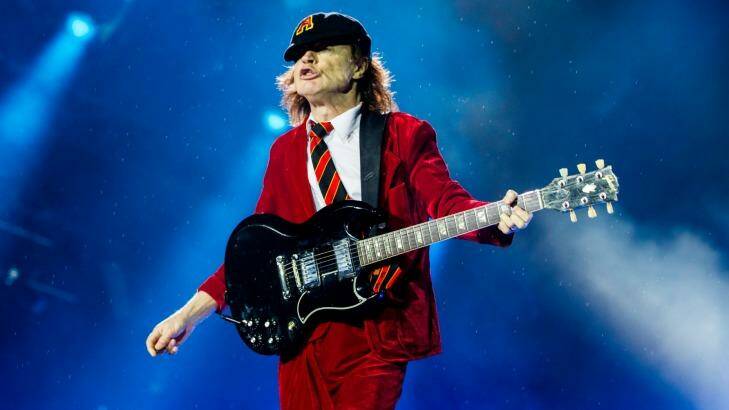 AC/DC guitarist Angus Young with his deep maroon Gibson SG guitar. Balter Beer's head brewer Scott Hargrave once brewed a dark lager inspired by the guitar's deep rosewood colour. Photo: Edwina Pickles