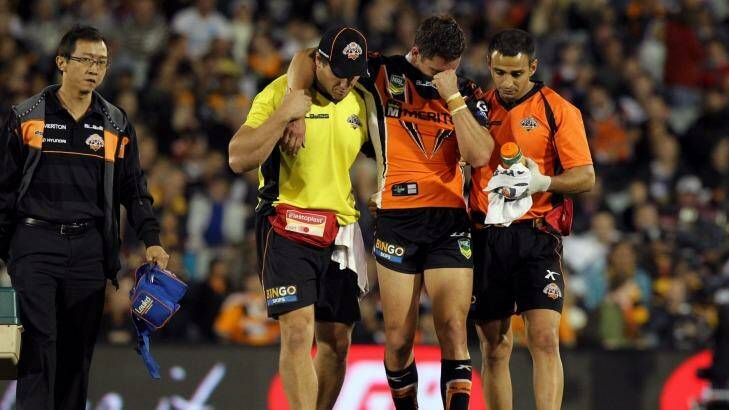 Familiar sight: Tim Moltzen leaves the field injured in round 7, 2013. Photo: Jonathan Ng
