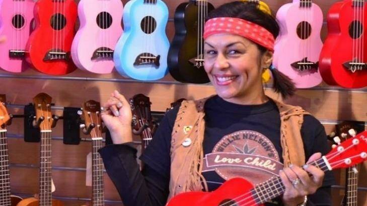 Sandra Beynon of Willie Nelson's Love Child at the Red Hill guitar shop with some of the donated ukuleles. Photo: Sandra Beynon