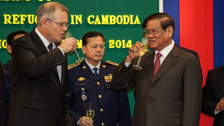 Immigration Minister Scott Morrison and Cambodian Interior Minister Sar Kheng toast their deal in September last year. Photo: Omar Havana