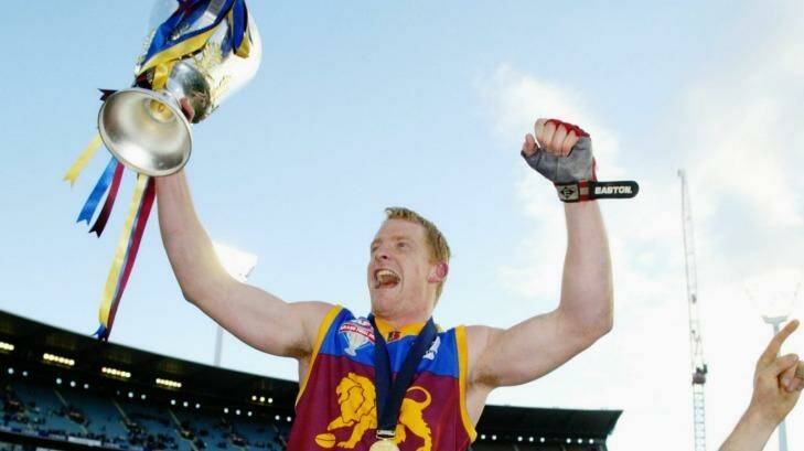 Hat-trick: Michael Voss and the Lions celebrate in 2003. Photo: Heath Missen