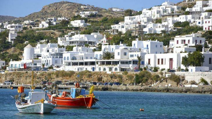 Mykonos' harbour is surrounded by gleaming white houses, resorts and developments.
 Photo: iStock.