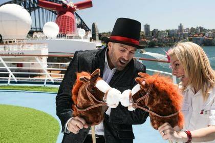 Cruise Director Eli and Senior Maitre'd Dessi compare horses on board Carnival Spirit.
