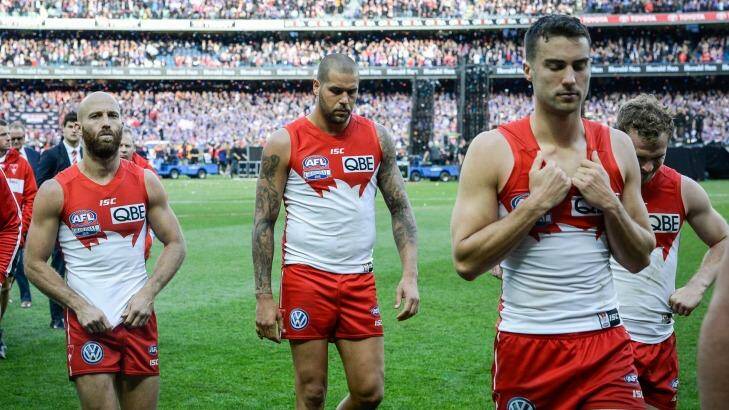 Tough to take: Dejected Swans players leave the field. Photo: Justin McManus