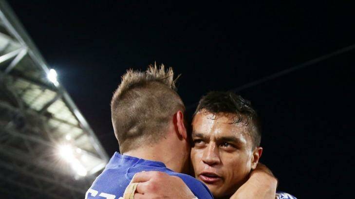 Josh Reynolds (left) of the Bulldogs celebrates victory with Sam Perrett (right) at the end of the NRL second preliminary final match between the Penrith Panthers and the Canterbury Bulldogs at ANZ Stadium, Sydney, on September 27 in 2014. Photo: Matt King
