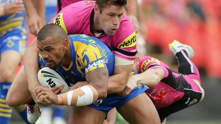 Handful:  Manu Ma'u is tackled during a full blooded Trial Match between the Panthers and Eels. Photo: Mark Metcalfe