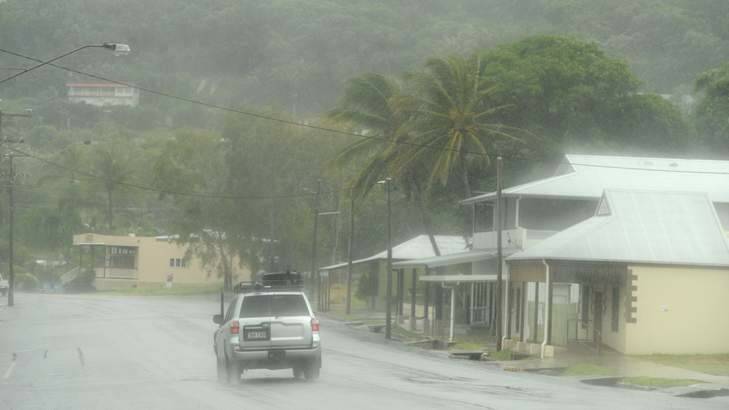 A car drives through torrential rain from Cyclone Ita Photo: Orlando Chiodo