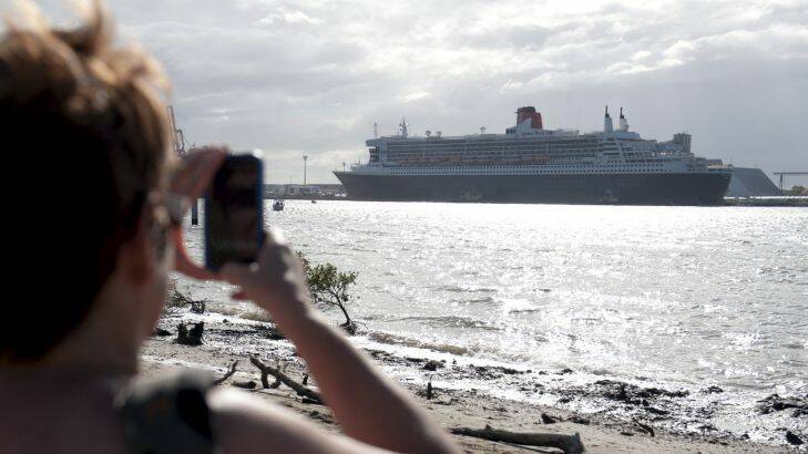 a spectator takes a picture of The queen Mary 2 from luggage Point across the river from its Dock at Fisherman Island.16th of February 2012. Photo: Harrison Saragossi Photo: Harrison Saragossi