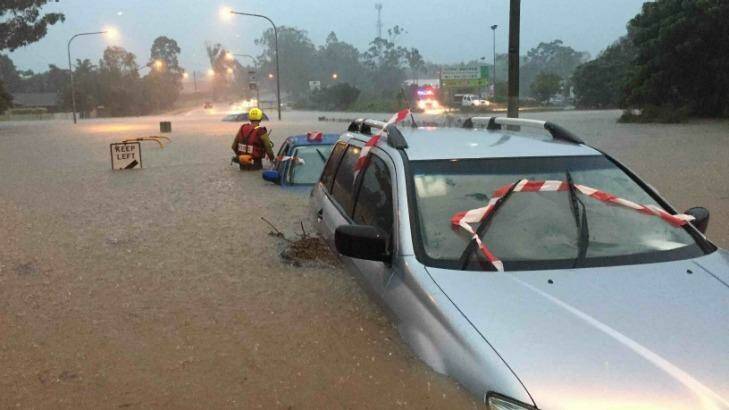 A car under water during severe weather in SEQ on Friday. Photo: Queensland Fire and Emergency Se