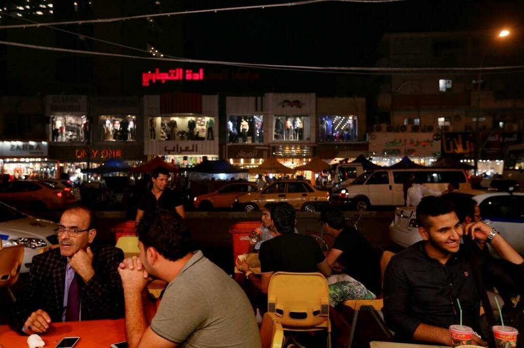 Normal life: Iraqis at a restaurant in the Karada district of the capital.  Photo: Kate Geraghty