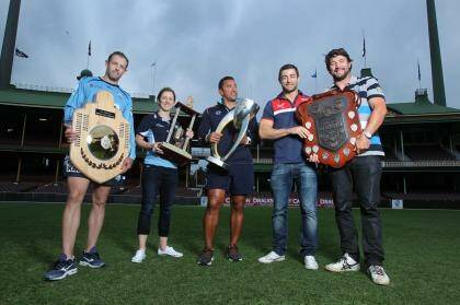 State of domination: NSW cricketer Ben Rohrer, NSW Breakers' Rachael Haynes, Waratahs assistant coach Daryl Gibson and former NRL stars Anthony Minichiello and Nathan Hindmarsh hold aloft their sporting trophies at the SCG. Photo: Louise Kennerley