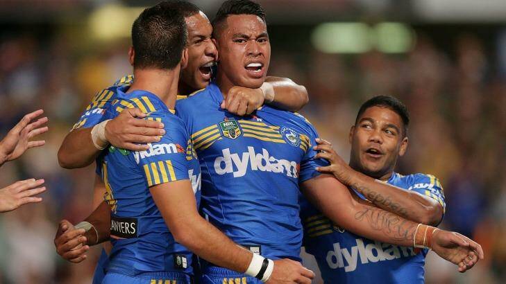 Making a name for himself: Eels winger John Folau celebrates after scoring the first of his two tries. Photo: Mark Metcalfe