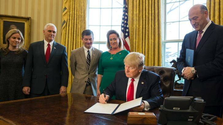 US President Donald Trump signs an executive order calling for a rewriting of major provisions of the 2010 Dodd-Frank Act. Photo: New York Times