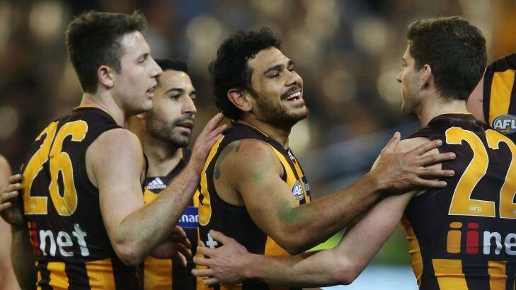 Hawthorn's Cyril Rioli celebrates with teammates after one of his six goals.