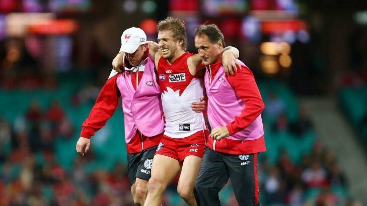 Knee injury: Kieren Jack of the Swans is assisted from the field. Photo: Matt King