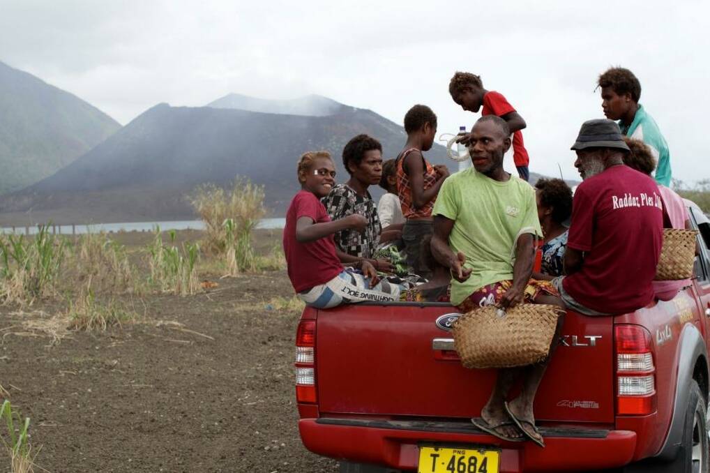 Danger zone: Matupit villagers in front of Mount Tavurvur volcano near Rabaul, Papua New Guinea. Photo: Janie Barrett