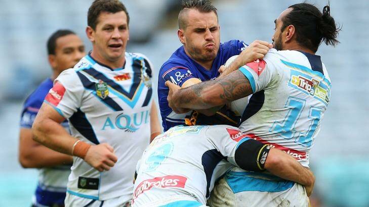 SYDNEY, AUSTRALIA - APRIL 23: Josh Reynolds of the Bulldogs  is tackled by the Titans defence during the round eight NRL match between the Canterbury Bulldogs and the Gold Coast Titans at ANZ Stadium on April 23, 2016 in Sydney, Australia.  (Photo by Brendon Thorne/Getty Images) Photo: Brendon Thorne