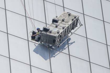One of two window-washers is pulled to safety. Photo: New York TImes