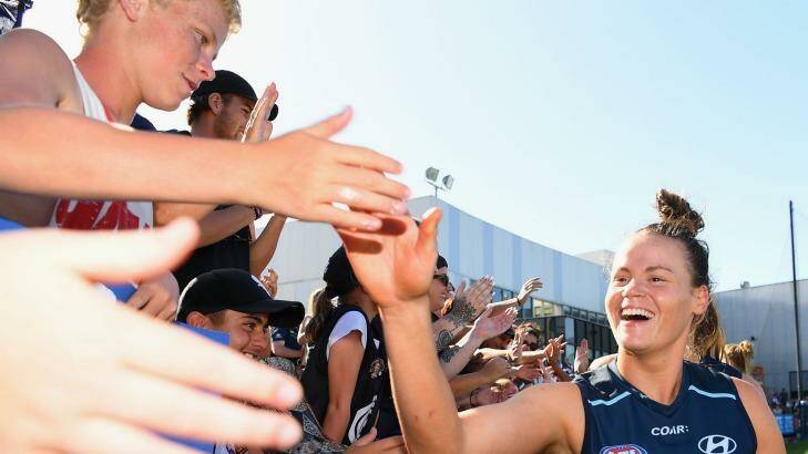 Skin in the game: Brianna Davey shares a moment with Carlton fans. Photo: Quinn Rooney