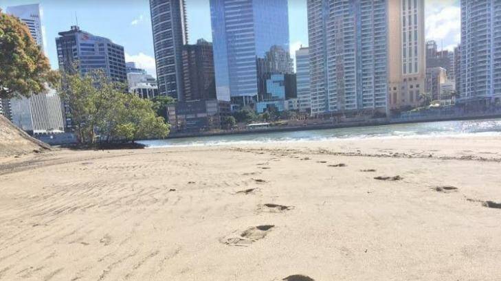 Footsteps in the beach sand at Brisbane River's CBD beach, under the Story Bridge. Photo: Tony Moore