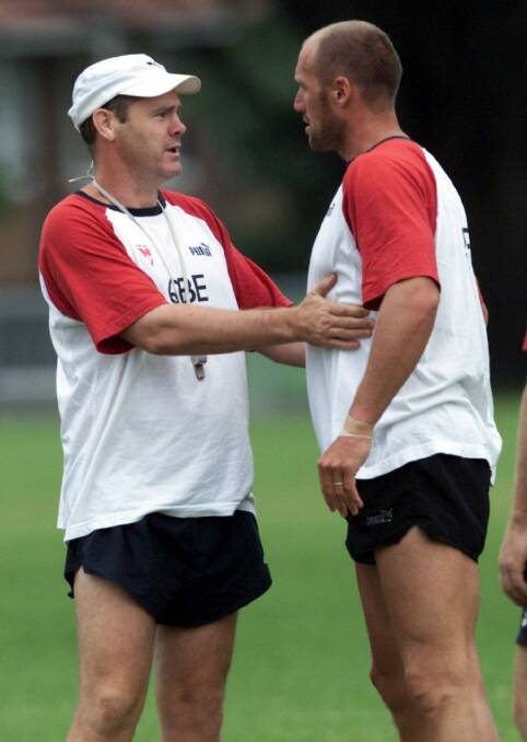 Rodney Eade and Tony Lockett chat at training in 2002. Photo: Simon Alekna