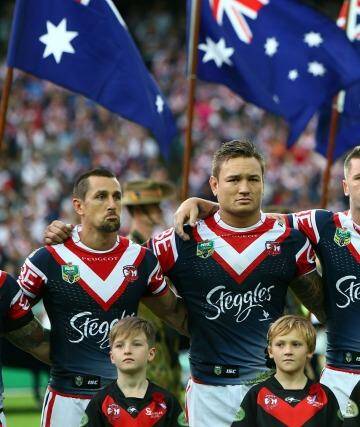Solemn: Roosters players before the Anzac Day match. Photo: Renee McKay