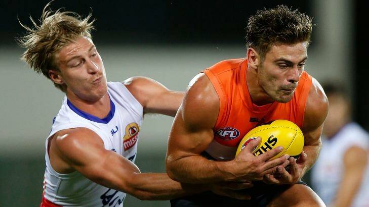 Biggs, left, competes for the ball against GWS. Photo: Michael Willson/AFL Media
