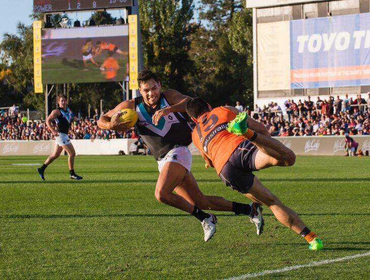 15 April 2017. AFL Round 4. Greater Western Sydney Giants v Port Adelaide Power at Manuka Oval/UNSW Canberra Oval.Giants' Matthew Kennedy tries to catch the Power's Jarman Impey.
Photo: Sitthixay Ditthavong
