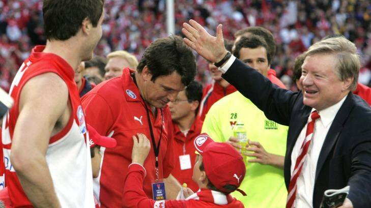 Champions: Richard Colless celebrates the Swans' 2005 premiership with Paul Roos. Photo: Vince Caligiuri