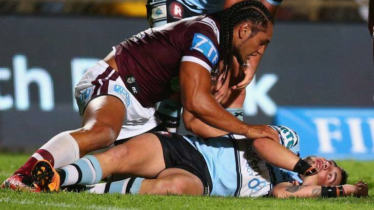 SYDNEY, AUSTRALIA - MARCH 21:  Martin Taupau of the Eagles shows concern for Jack Bird of the Sharks as he lies injured on the ground during the round three NRL match between the Manly Sea Eagles and the Cronulla Sharks at Brookvale Oval on March 21, 2016 in Sydney, Australia.  (Photo by Mark Kolbe/Getty Images) Manly forward Martin Taupau received one week ban for his swinging arm which knocked out Cronulla's Jack Bird in round three. Photo: Mark Kolbe