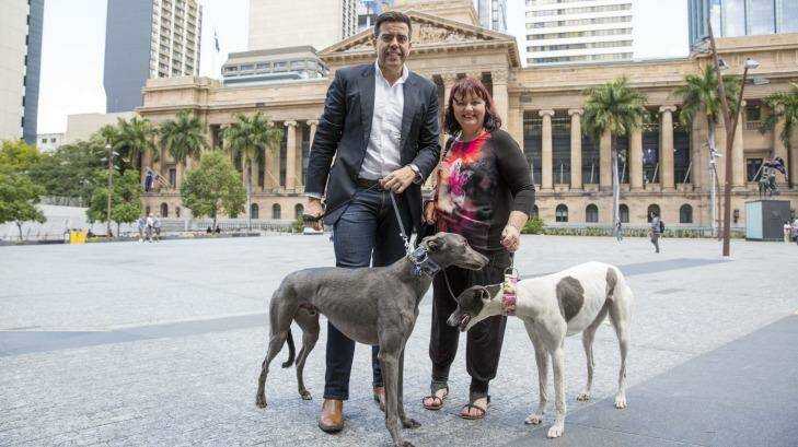 Lisa Paxton and Councillor Milton Dick with two beautiful greyhounds. Photo: Glenn Hunt