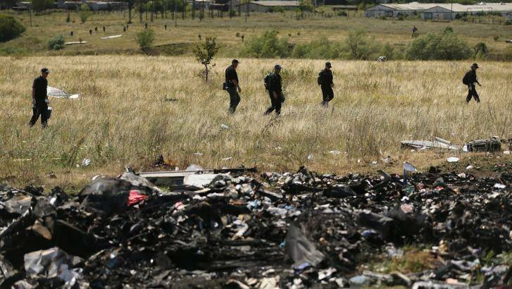 Australian Federal Police and their Dutch counterparts search the crash site. Photo: Kate Geraghty